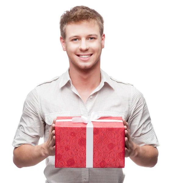 Young casual man hoding christmas gift — Stock Photo, Image