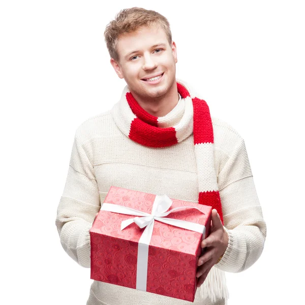 Attractive young man holding red gift — Stock Photo, Image