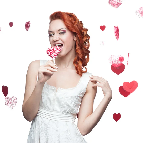 Surprised red-haired woman holding lollipop — Stock Photo, Image