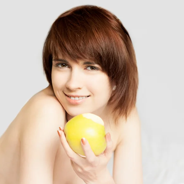 Red-haired girl lying with apple — Stock Photo, Image