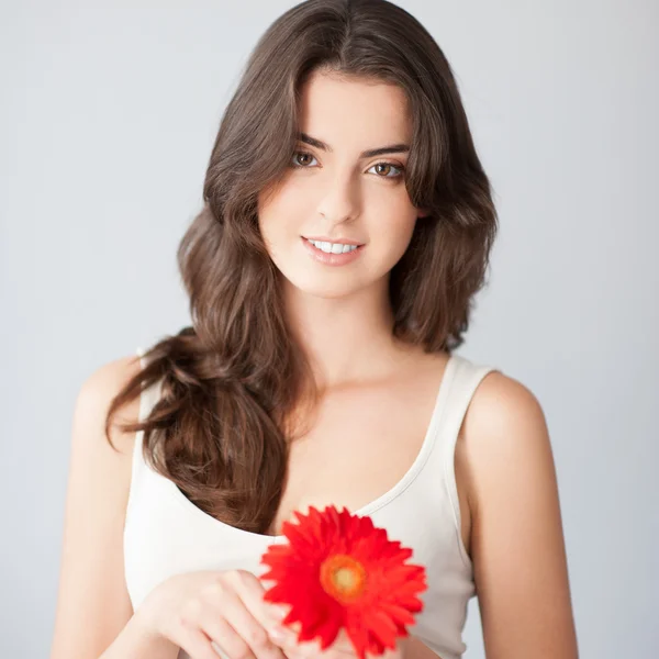 Beautiful girl with red flower — Stock Photo, Image