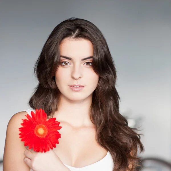 Beautiful girl with red flower — Stock Photo, Image