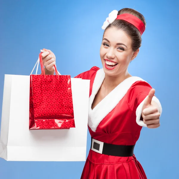 Cheerful retro girl holding shopping bags — Stock Photo, Image