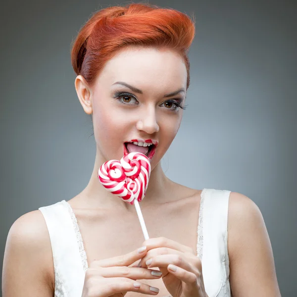Red woman holding lollipop — Stock Photo, Image