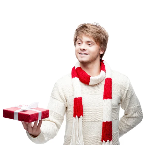 Young smiling man holding christmas gift — Stock Photo, Image