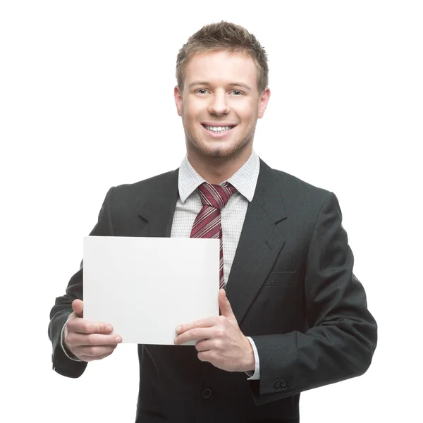 Joven hombre de negocios sonriente sosteniendo cartel — Foto de Stock