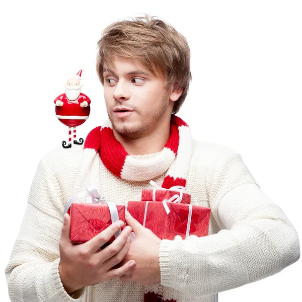 Young funny man holding christmas gifts — Stock Photo, Image