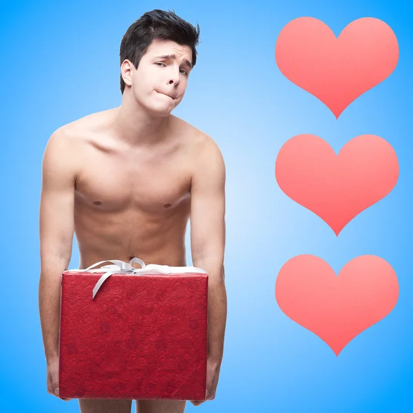 Funny naked young man with gift — Stock Photo, Image