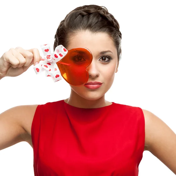 Brunette woman holding lollipop — Stock Photo, Image