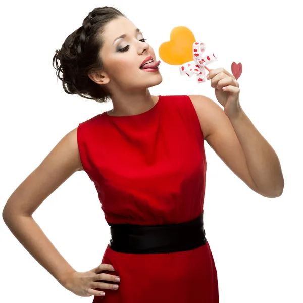 Brunette woman holding lollipop — Stock Photo, Image