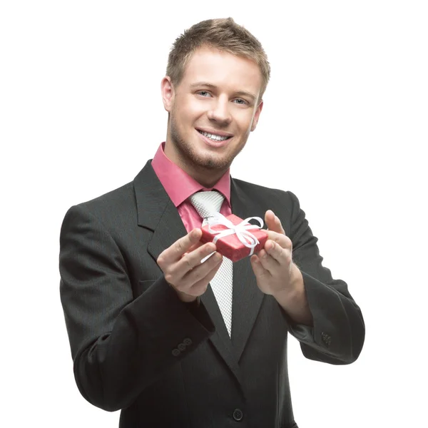 Businessman holding small red gift — Stock Photo, Image