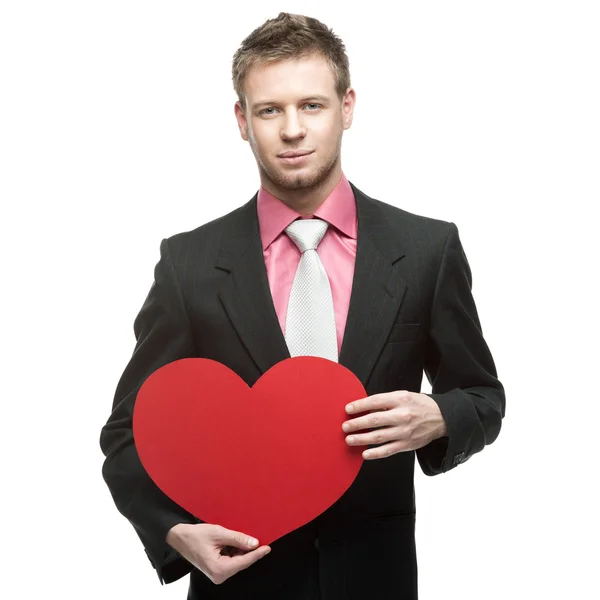 Cheerful businessman holding red heart — Stock Photo, Image