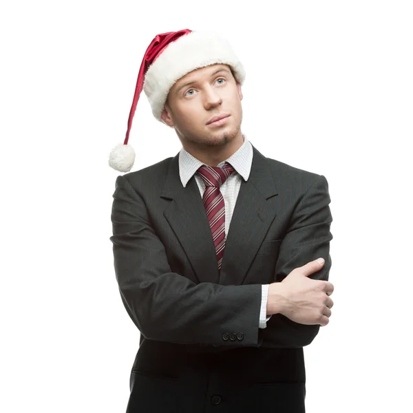 Young thoughtful businessman in santa hat Stock Image