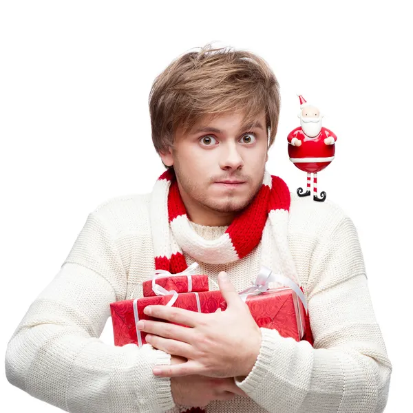 Young funny man holding christmas gifts — Stock Photo, Image