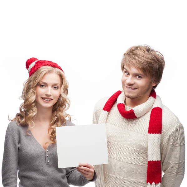 Young happy christmas couple holding sign — Stock Photo, Image