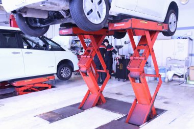 A scene of regular inspection and maintenance work on the car.