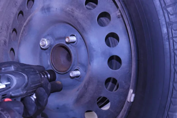 A scene of tire replacement work at a car repair shop.