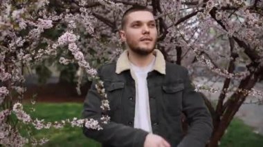 Genç adam kameraya gülümsüyor.