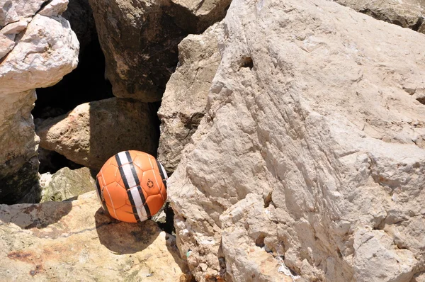 Ball near the ocean rocks