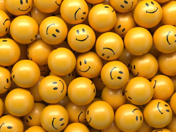 Gelbe Kugeln mit lustigen Smiley-Gesichtern — Stockfoto