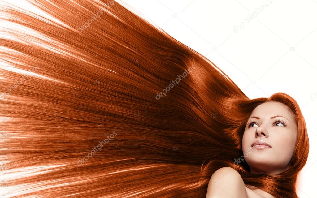 Close-up portrait of a beautiful young woman with elegant long red healthy straight shiny hair, isolated on white background