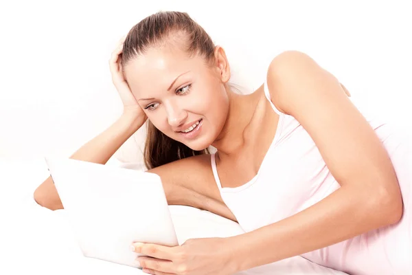 Smiling young beautiful woman with a tablet pc computer at home — Stock Photo, Image