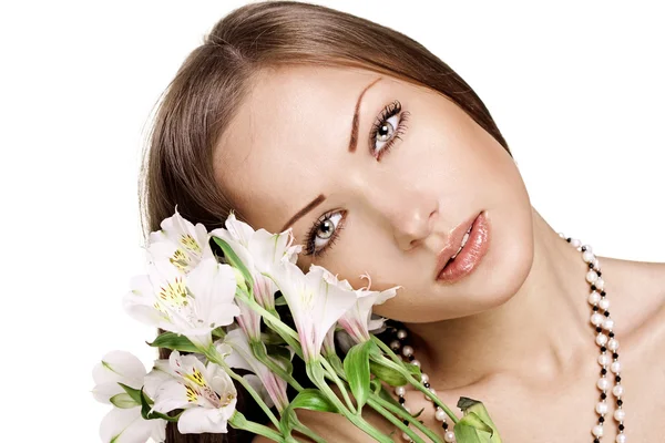 Sensual young woman with perfect clean skin holding flowers — Stock Photo, Image