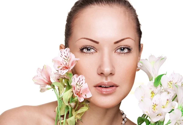 Sensual young woman with perfect clean skin holding flowers — Stock Photo, Image