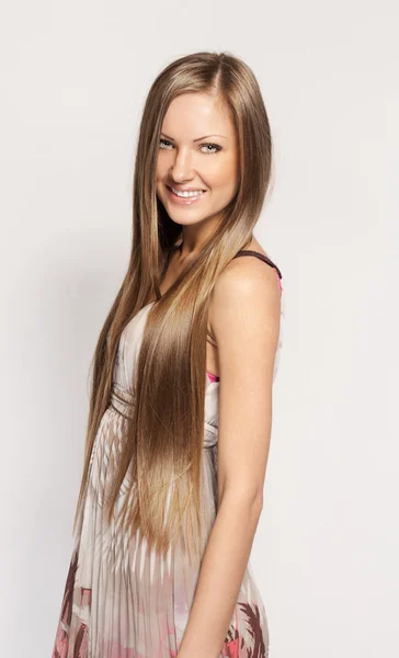 Young beautiful smiling woman with long shiny hair, in long dress, fashion model posing — Stock Photo, Image