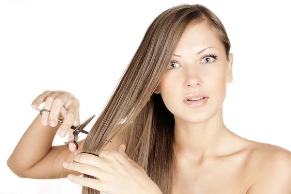 Smiling attractive woman with long beautiful hair holds scissors — Stock Photo, Image