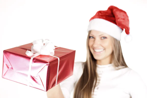 Happy beautiful woman in Santa hat holding Christmas gift — Stock Photo, Image