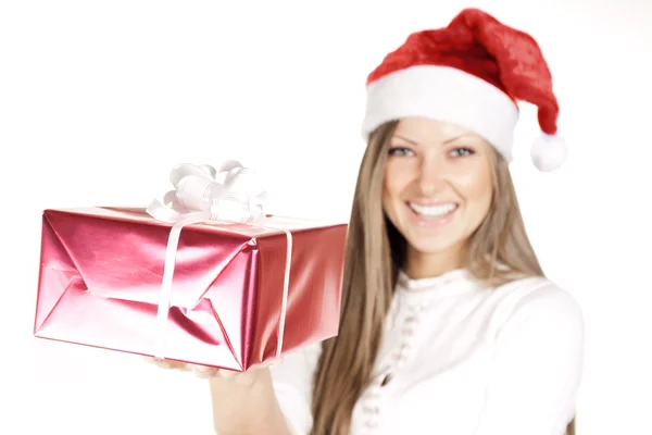 Happy beautiful woman in Santa hat holding Christmas gift — Stock Photo, Image