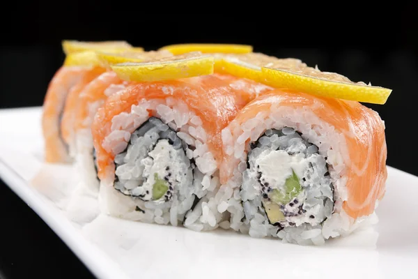 Close-up of a sushi rolls on a white plate — Stock Photo, Image