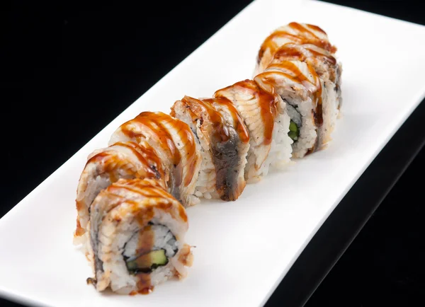 Close-up of a sushi rolls on a white plate — Stock Photo, Image