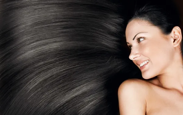 Egy gyönyörű fiatal nő, elegáns hosszú, fényes haj, frizura fogalmi közeli portréja Stock Fotó