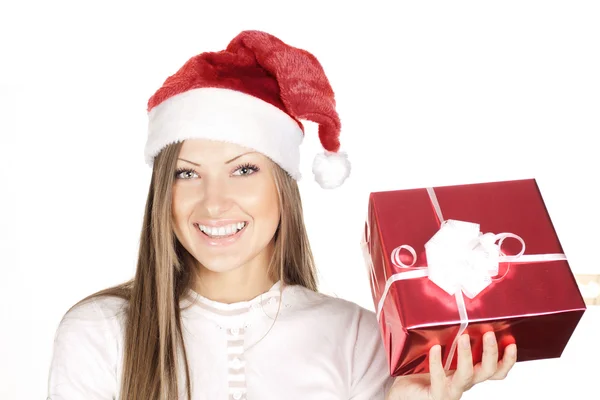 Happy beautiful woman in Santa hat holding Christmas gift Stock Image