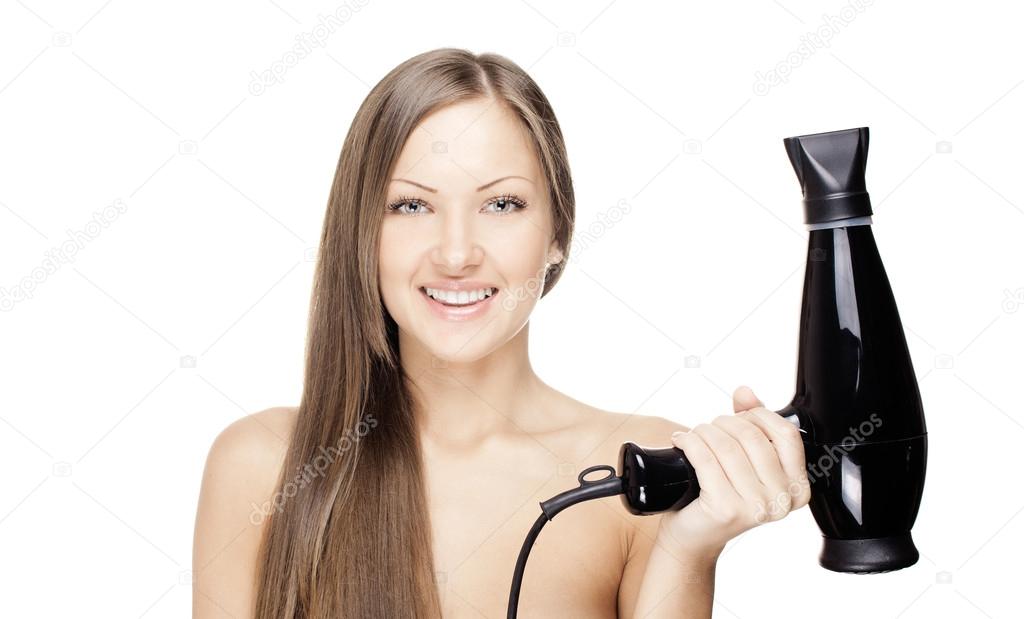 Smiling beautiful woman drying her beautiful long hair with hairdryer