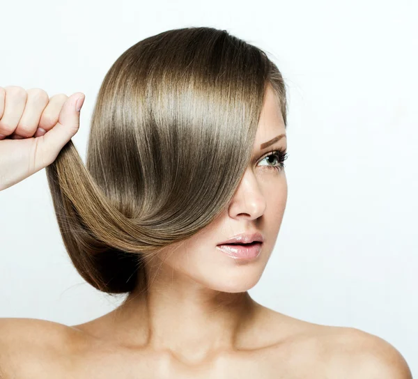 Young attractive woman holding her hair — Stock Photo, Image