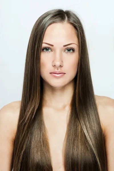 Closeup portrait of a beautiful young woman with long hair — Stock Photo, Image