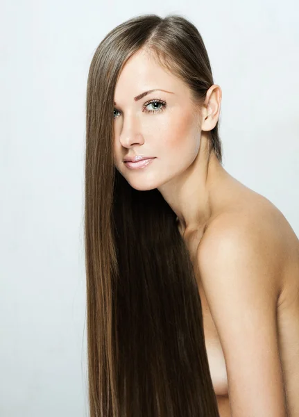 Closeup portrait of a beautiful young woman with long hair — Stock Photo, Image