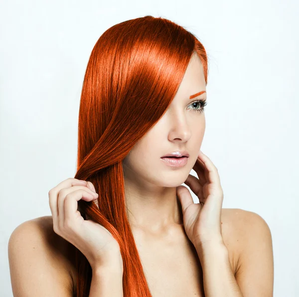 Beautiful young red-headed woman with long shiny hair — Stock Photo, Image