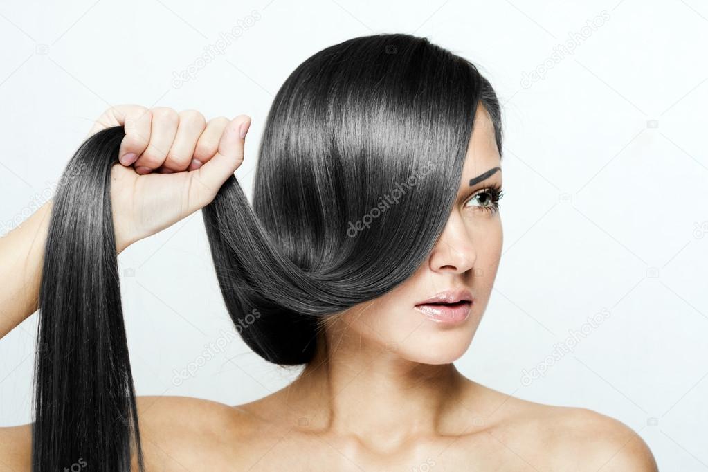 Young attractive woman holding her hair