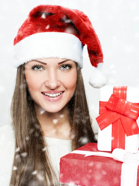 Young smiling woman holding Christmas present — Stock Photo, Image