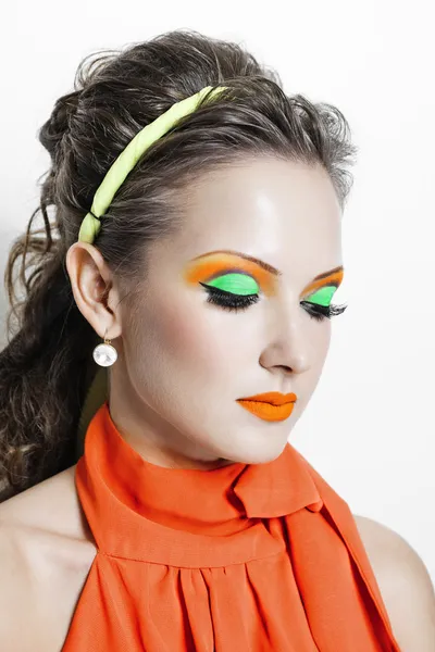 Portrait of a beautiful woman in orange dress — Stock Photo, Image