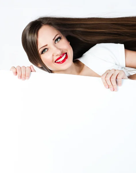 Young brunette holding a blank billboard — Stock Photo, Image