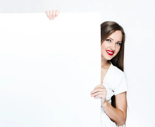 Pretty woman holding white blank board — Stock Photo, Image