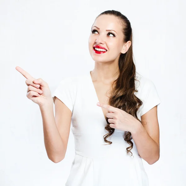 Pretty brunette pointing at something — Stock Photo, Image