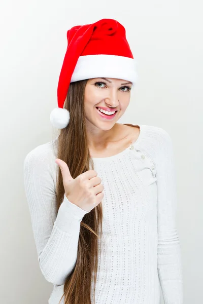 Ragazza in cappello Babbo Natale e mostra pollice in su — Foto Stock