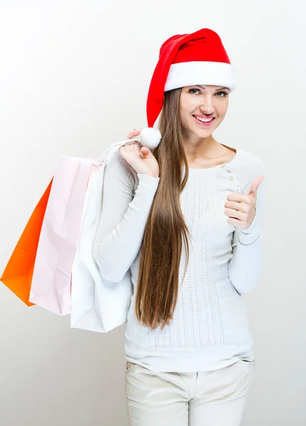 Weihnachten Weihnachtsmann Hut Frau mit Einkaufstaschen. — Stockfoto