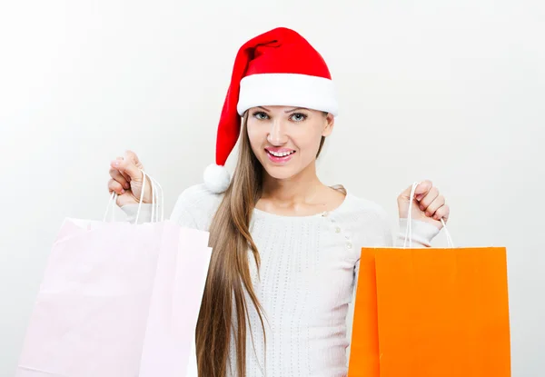 Christmas Santa hat woman with shopping bags. — Stock Photo, Image